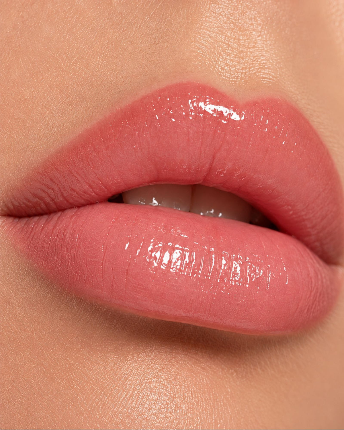 Lips in Luxe Gloss, a neutral-to-cool shade calibrated to the smile